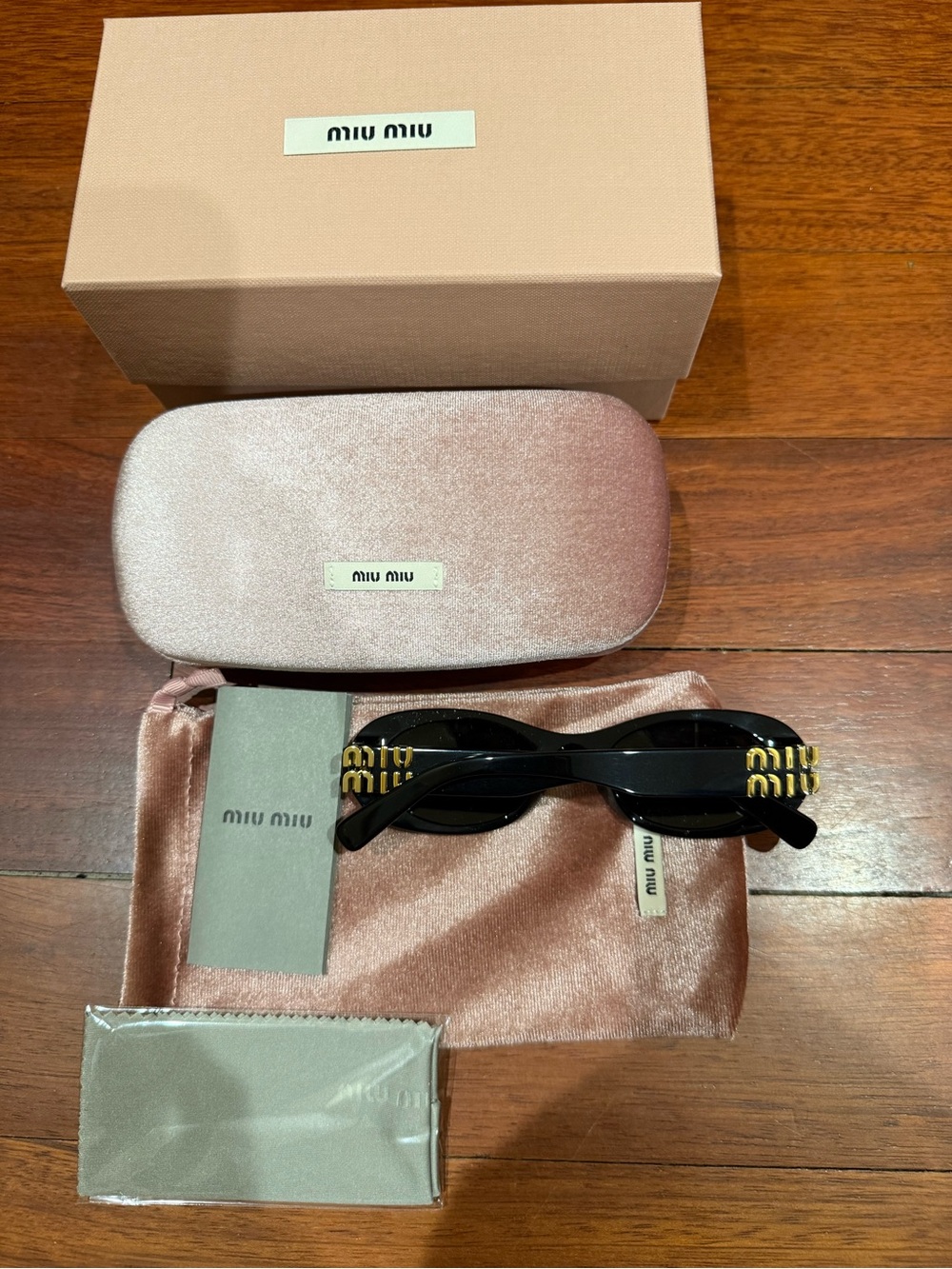 Miu Miu MU06ZS Black Sunglasses with Gold Logo